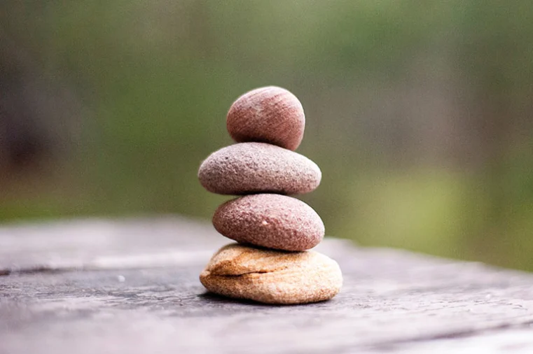 Smooth stones balanced in a stack, symbolising calm, balance, and mindfulness.